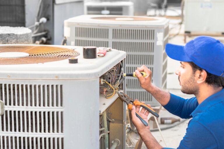 An HVAC technician checks HVAC systems, which includes cleaning, inspection, and filter changes.