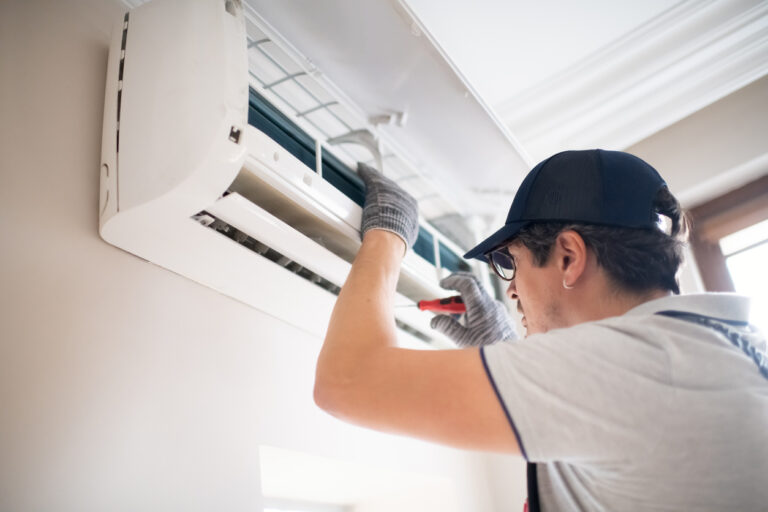 HVAC installation estimate - An HVAC Comfort Advisor installing an air conditioner unit.